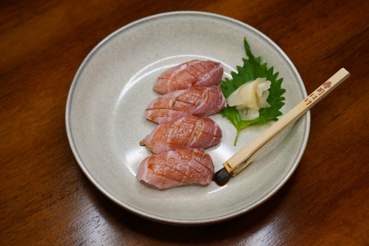 Seared toro nigiri, four pieces on a shiso leaf