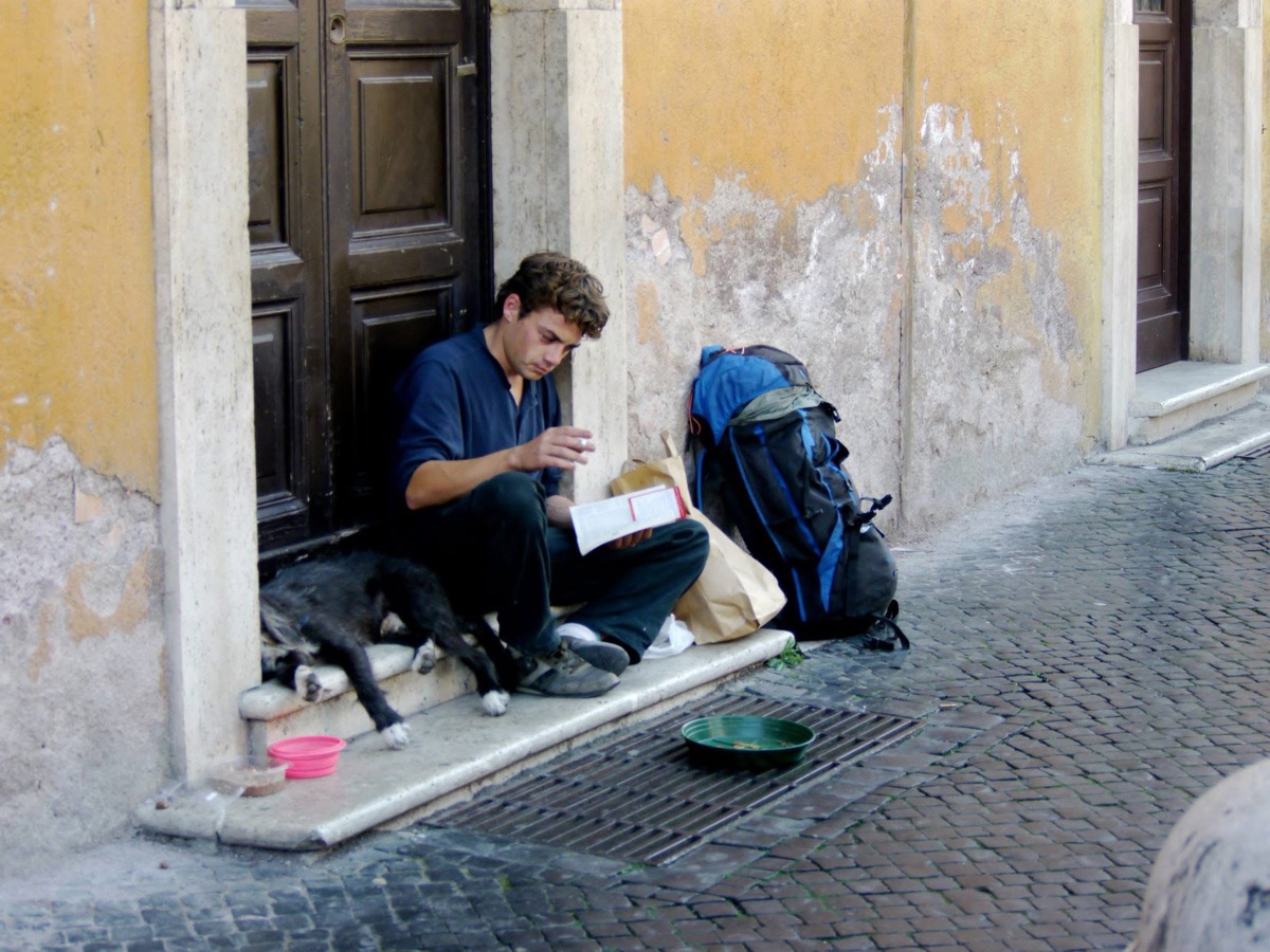 A doorway in Rome, a dog asleep across his legs